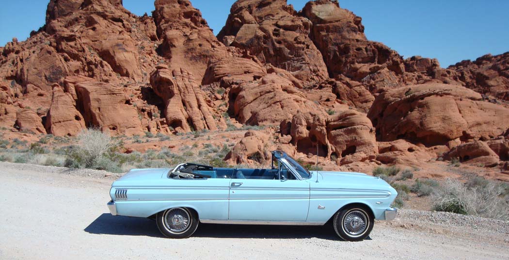 It all began when I was 13 years old.  I had saved $300 over the course of three years mowing yards with my grandpa in southern Illinois in a small town, McLeansboro, IL.  While going through the classifieds of the local newspaper I came across an ad for a car and decided that I wanted it.  It was a 1972 Opel.  I talked my grandpa into taking me to go see it (which was easy because he once owned an Opel and loved it).  And yes, I was only 13 at the time but you have to take in consideration that this was back in the late 70's / early 80's and I lived on a farm in rural America.  My grandpa negotiated for me, bought the car for $350 and drove it home for me as it was over 40 miles from my house.  The fireworks began when I got the car home because I hadn't asked my parents for approval!  Before anyone gets any grandeurs  about it being an Opel GT, it wasn't.It was a 1972 Opel Ascona A 1.6S.  I drove the car around the farm and throughout the country on gravel roads until I turned 16 years old.  And that's when I saw my very first Ford Falcon.There was a guy that always hung out at the gas station that I helped my parents run who wanted help working on a baby blue, 1964 Ford Falcon convertible.  Eager to learn body work and to see the car I readily agreed (actually at 16, I was more interested in seeing the convertible car verses actually having to do any work on it).  I thought the car was the coolest car I had ever seen.  We worked on the body, filled in more rusted out areas with bondo than one would think possible, sanded the entire car down and repainted it baby/powder blue. Knowing how much I loved the car and eager to make some cash, the guy traded me the Falcon for my Opel (which I had driven into the ground) and $300 cash.  I couldn't believe that I was now the proud owner of a convertible!!  Who cared if the rear clear vinyl window was now a solid color of rust that you couldn't see through, or that there were spots in the upholstery that needed repaired, or that the car used oilit was a convertible and I was 16 years old!   I drove the car during my junior and senior years of high school up until the brakes went out on it at which point I parked the car on the farm.  However, we had a billy goat who loved to climb and it climbed onto the top of the convertible and fell through to the front seats the first time and the second time into the back seat.  And to add insult to injury, my dad's breaks on his truck went out and rolled back into the side of my car just behind the driver's door into the rear panel thus knocking out one big chunk of bondo!  It was at that point that I decided to park the car in a safe place on the farm and put a tarp over the top of it to keep the rain out.  One year later I moved to Nevada to attend UNLV but never forgot about my Falcon.My ten year high school reunion was approaching so I decided to drive my truck to Illinois and haul my Falcon back to Nevada so that I could work on it.  After 9 years of sitting in the dirt, the tires had went flat but to my surprise they actually aired up!  I was able to get it onto a trailer and off to Las Vegas, NV we went.  After getting it back to Las Vegas, I was able to really check it over to see what needed to be done to it.  Sometime during the past 10 years the tarp had blown off.  The floor pans started collecting water and snow which caused the floor pans to rust away to nothing, the vinyl interior was shot and the seat frames had also rusted away.  Being the optimistic person that I am, I figured some new floor panels would do the trick and we'd be on the roads in no time.  Sadly, due to the unibody construction of the Falcon, the rocker panels weren't being held in place by hardly anything at the front of the car because of the extreme rusting.  I was heartbroken.  My dream car was to remain only a dream (ironically enough, I still have it parked in my back yard!!).Determined to drive a Falcon I decided to buy a parts car that had a good body that I could transfer my convertible engine and transmission into.   I found such a car on good ole Ebay and to my surprise, the car was located in North Las Vegas.  I couldn't believe my luck!  I won the bid for $1,350.  I had the car hauled to my house and just knew that I would be on the road within a few months.  However, life had other plans for me and I ended up working ten to twelve hours a day five and seven days a week and never found the time to work on the car.  My original Falcon was parked in my backyard and the one I had just purchased was parked in my driveway.Fast forward a few yearsI was still working crazy hours, still had two parts cars but did not have a Falcon to drive.  It was at that point that I had enough money to buy a car that was already in driving condition (which totally negated the joy of restoring a car myself) since I didn't have the time to actually work on one.  Funny how life works out.  I looked around Vegas for a Falcon but couldn't find any that I wanted.  I really wanted a car that was either just like the one I had in high school or very similar.  Back to good ole Ebay.  For months I scoured through the listings until I finally found a car that was 90% the same type of car that I wanted with two big differences, instead of having a 6 cylinder it was a V8 and instead of having bucket seats, it was a bench seat.  The positives by far outweighed those to differences:  I decided that this was the car for me and bought it before the sale ended.  Woo Hoo!!! I finally had a Falcon Convertible once again.  Bad part, which there always seems to be oneI was still working 10-12 hours a day in Las Vegas, NV and the car was located in Appleton, WI.  I was due for a vacation and instead of having the car shipped to NV I decided that I would fly to Wisconsin and drive the car back.  The gentleman that I bought the car from agreed to store the car for me until the end of August, 2006.  To my surprise he further agreed to pick me up at the airport to take me to the car so that I could drive it back to Nevada.  After living in Las Vegas for more years than I care to mention, his generosity and genuine thoughtfulness was a pleasant surprise.   We had exchanged several e-mails and phone calls before I arrived at Appleton airport and struck up a friendship.  Once again, he surprised me by having the oil changed and the transmission oil & filter changed so that the car would be ready for the road trip.I solicited my friend, Elton, to fly to Appleton with me and assist with driving the car back to Las Vegas.  The gentleman actually brought the car to the airport so that I didn't have to find my way back to the freeway from where he had it stored.  Wow, super nice guy!  When I crawled into the driver's seat I felt like I was in high school all over again.  Woo hoo!!  I put the top down and we were on the road, finally in my 1964 Ford Falcon convertible.  We weren't too far out of Appleton when a car full of girls went to pass us by on the freeway.  They kept looking at my car, I kept looking at them and the next thing I know, two of them pulled up their shirts and flashed us.  I love this car!  I looked over to my buddy to see if he saw what had happened and he was passed out, missed the entire thing.We drove straight from Appleton to Denver where we had to stay the night because the generator quit.  We looked around for someone that could fix it but rather than wasting the time I decided to take a gamble.  1964 cars don't require a lot of electricity. The major things to run are the coil, turn lights and break lights.  I bought a new fully charged battery for the car and bought a small battery jumper battery pack.  We charged the battery jumper pack overnight in the hotel room and installed the new battery in the morning.  After putting one quart of oil in the engine we were on the road once more.  We made it to Las Vegas without further incident.  I was surprised that we only used one quart of oil the entire trip.  Not bad for an original engine that had 81,000 miles on it!